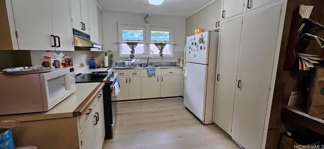 a kitchen with a sink cabinets and stainless steel appliances