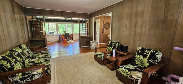 a living room with furniture floor to ceiling window and a table