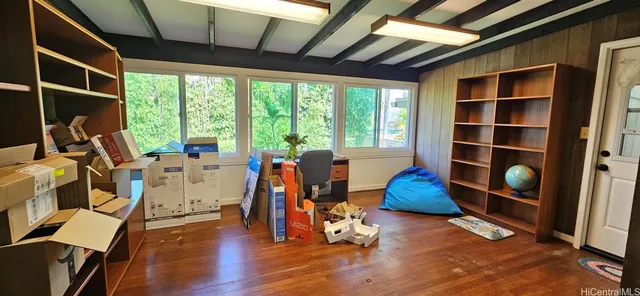 a view of gym room with wooden floor and windows