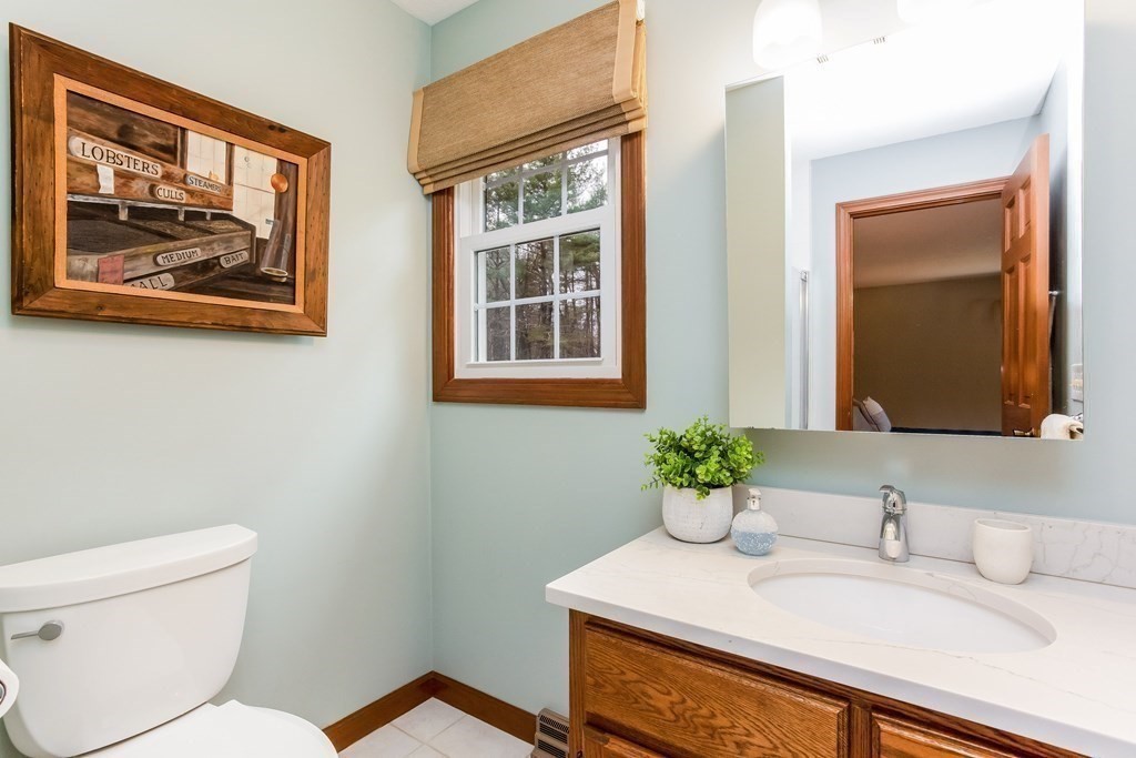 218 Somers Road Hampden, MA 01036 - Photo 18 of 32 a bathroom with a toilet sink and mirror