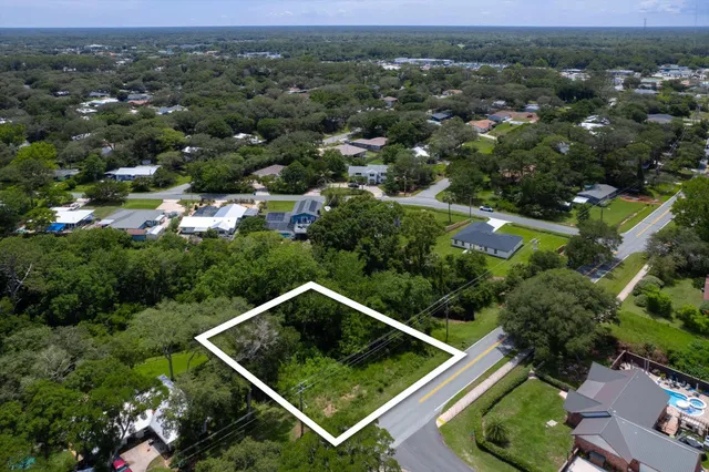 an aerial view of multiple houses with a yard