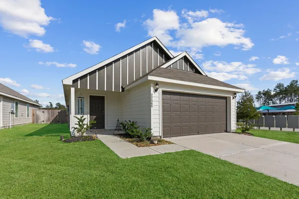 a front view of a house with a yard and garage