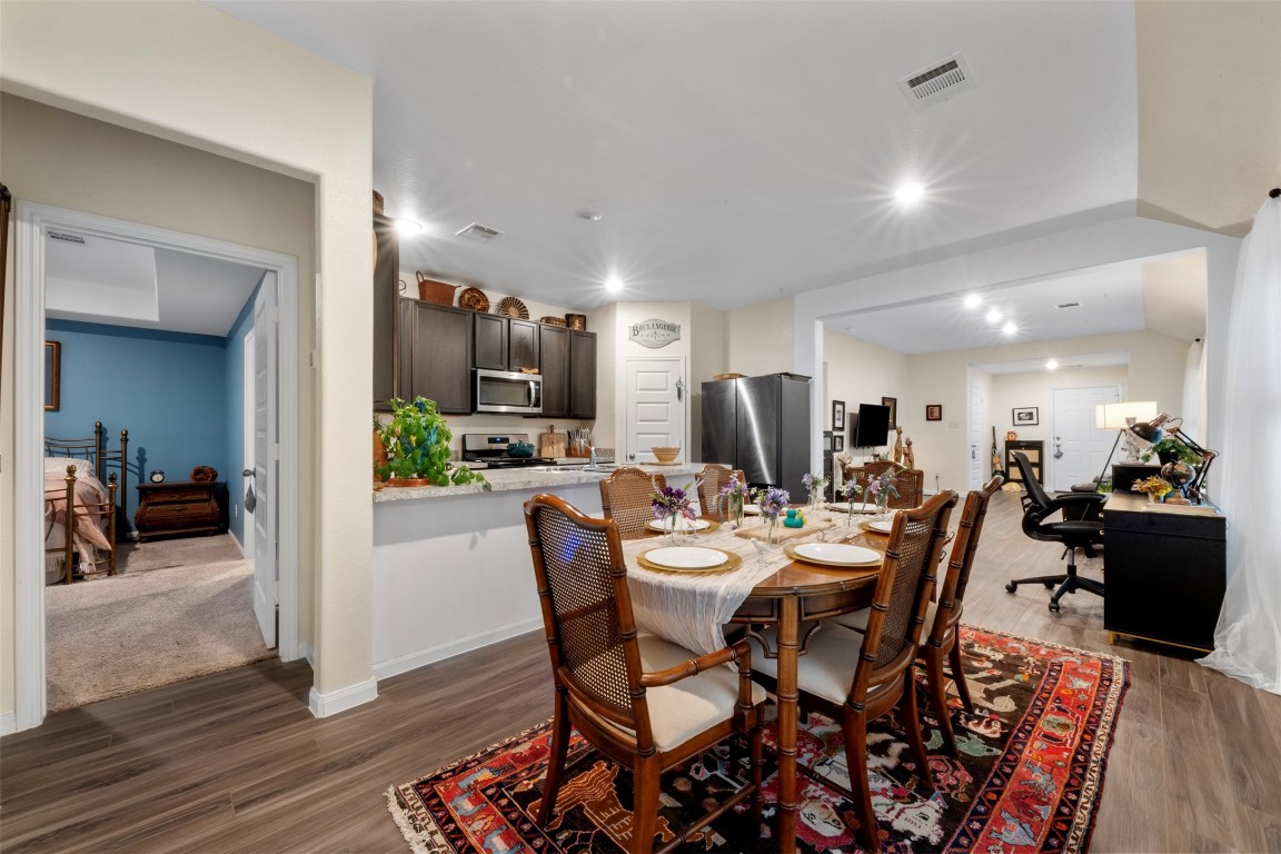 22565 Cormorant Court Splendora, TX 77372 - Photo 15 of 31 a view of a dining room with furniture wooden floor and a kitchen