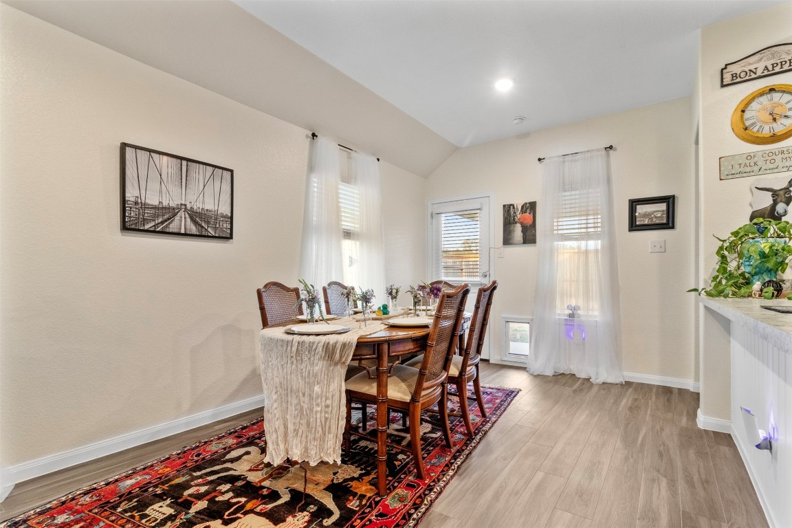 22565 Cormorant Court Splendora, TX 77372 - Photo 16 of 31 a view of a dining room with furniture and wooden floor