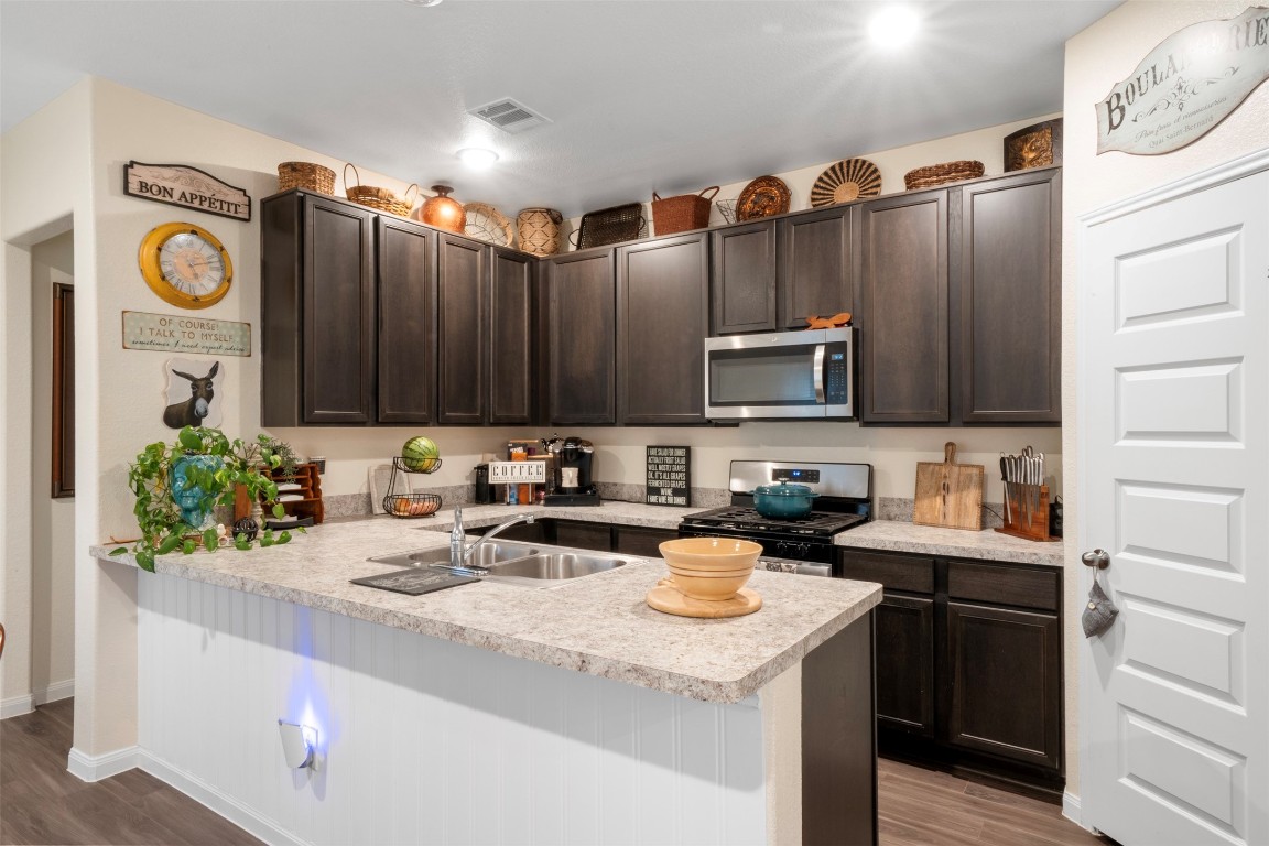 22565 Cormorant Court Splendora, TX 77372 - Photo 2 of 31 a kitchen with stainless steel appliances granite countertop a sink a stove and cabinets