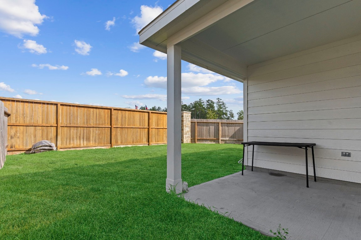 22565 Cormorant Court Splendora, TX 77372 - Photo 26 of 31 a view of backyard with large tree