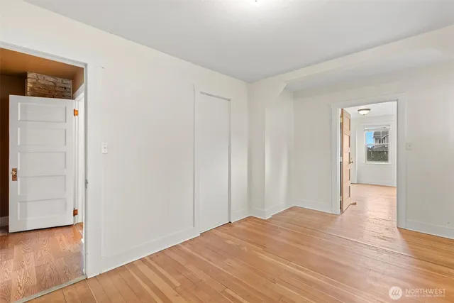 a view of a room with wooden floor and closet