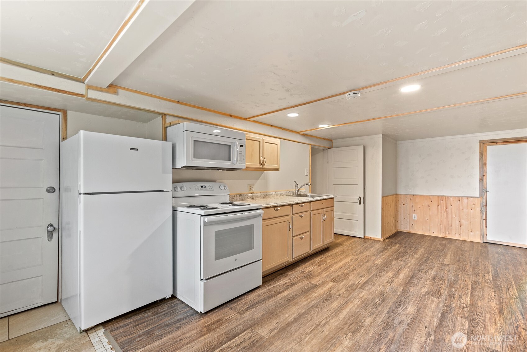 3724 School Street Wenatchee, WA 98801 - Photo 25 of 40 a kitchen with stainless steel appliances granite countertop a refrigerator a sink dishwasher a stove and white countertops with wooden floor