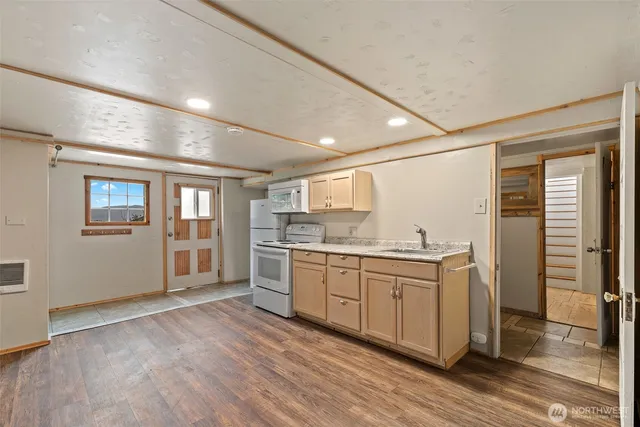 a kitchen with granite countertop a sink and cabinets