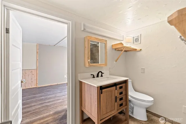 a bathroom with a toilet sink and mirror
