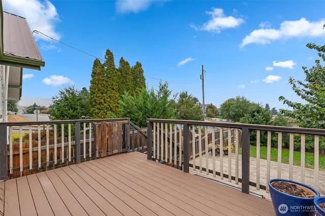a balcony with wooden floor and fence
