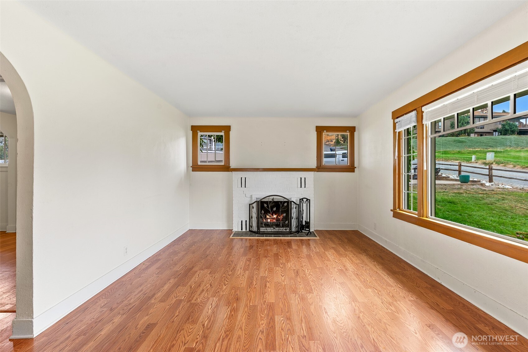 3724 School Street Wenatchee, WA 98801 - Photo 6 of 40 a view of a big room with wooden floor a fireplace and windows