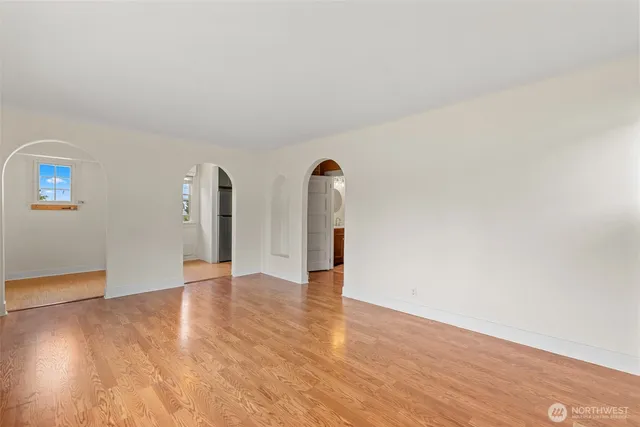 a view of an empty room with wooden floor