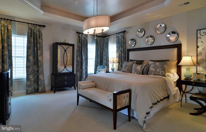 2505 Baileys Pond Road Accokeek, MD 20607 - Photo 6 of 16 a spacious bedroom with a bed and a chandelier