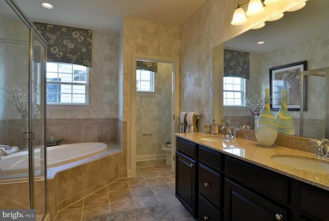2505 Baileys Pond Road Accokeek, MD 20607 - Photo 7 of 16 a bathroom with a double vanity sink and a mirror
