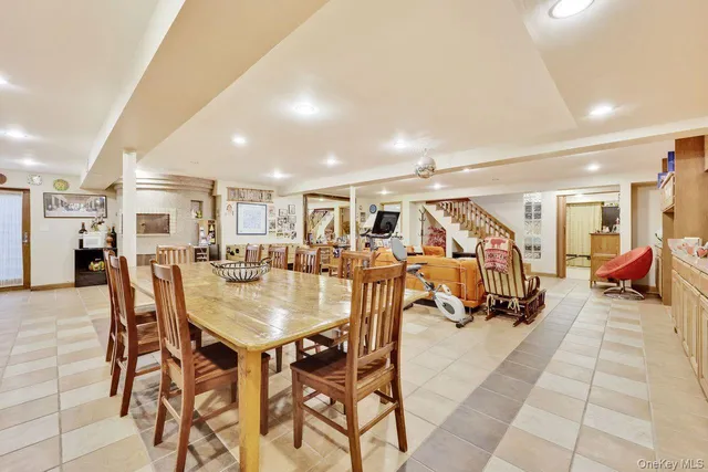 a living room with lots of furniture and a dining table with kitchen view