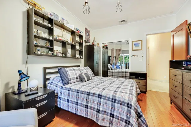 a bedroom with a bed window and flowerpot