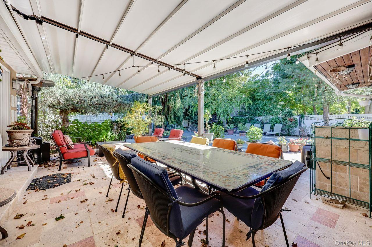 101 Harold Road Woodmere, NY 11598 - Photo 29 of 33 a outdoor dining space with furniture and outdoor view