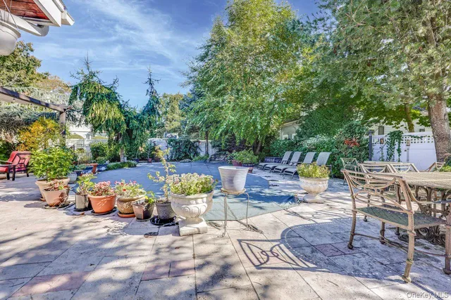 an outdoor space with patio furniture and potted plants