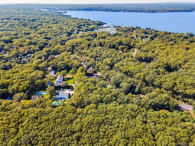 an aerial view of a houses with a yard