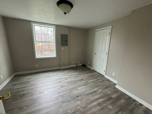 an empty room with windows and closet