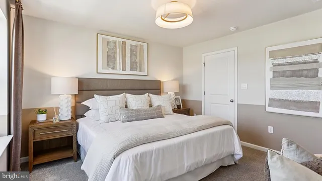 a bedroom with a bed and a lamp on table