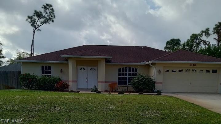 9148 Henry Road Fort Myers, FL 33967 - Photo 1 of 34 a front view of a house with a garden