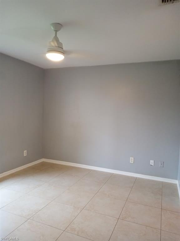 9148 Henry Road Fort Myers, FL 33967 - Photo 16 of 34 a view of an empty room with a chandelier fan