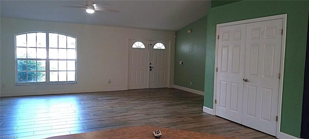 9148 Henry Road Fort Myers, FL 33967 - Photo 2 of 34 an empty room with wooden floor and windows