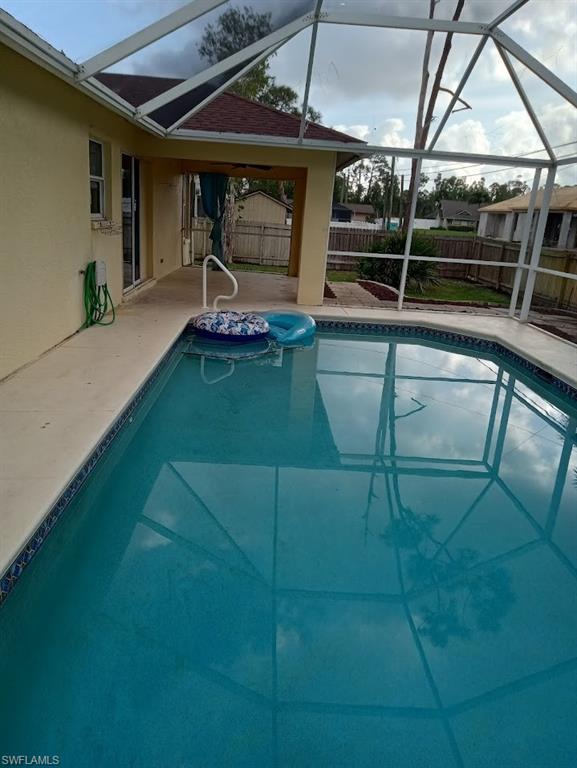 9148 Henry Road Fort Myers, FL 33967 - Photo 27 of 34 a backyard of a house with barbeque oven table and chairs