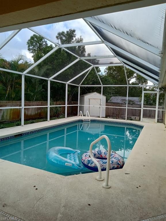 9148 Henry Road Fort Myers, FL 33967 - Photo 28 of 34 a view of a swimming pool with a garden