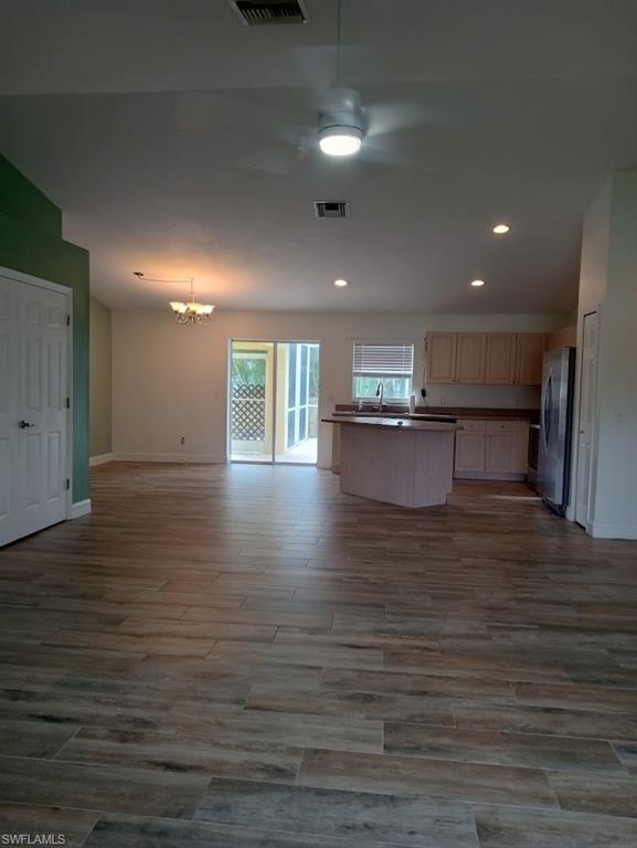 9148 Henry Road Fort Myers, FL 33967 - Photo 3 of 34 a view of kitchen and empty room with wooden floor