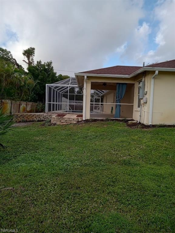 9148 Henry Road Fort Myers, FL 33967 - Photo 33 of 34 a front view of a house with a yard