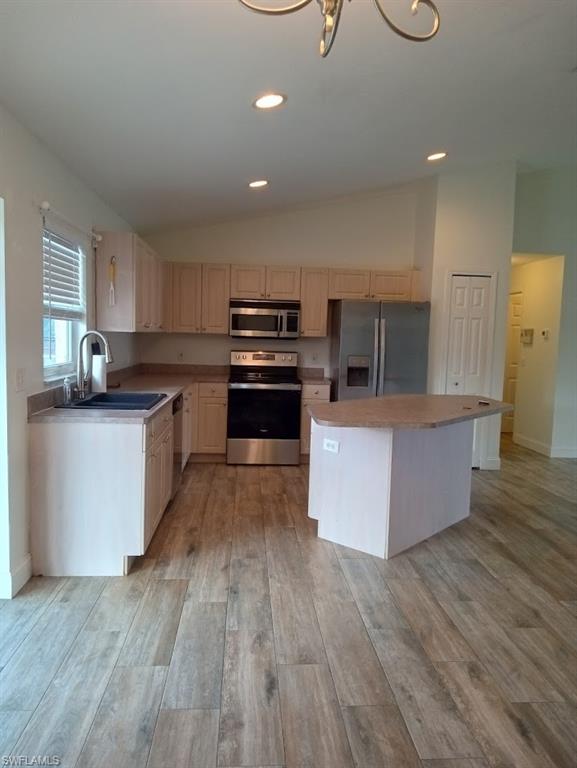9148 Henry Road Fort Myers, FL 33967 - Photo 4 of 34 a kitchen with stainless steel appliances kitchen island wooden cabinets and granite counter tops