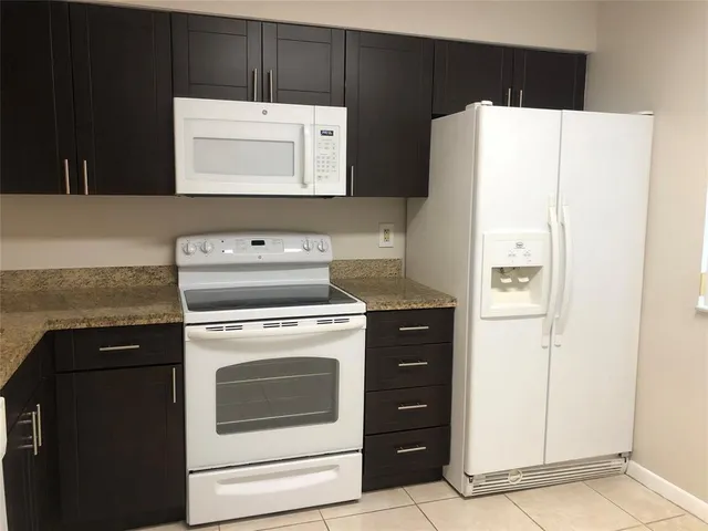 a kitchen with a stove and a refrigerator