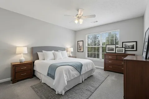 a bedroom with a bed and a television