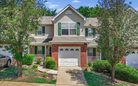a view of a house with wooden fence