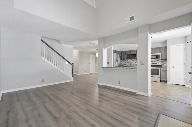 wooden floor and white cabinets in a room