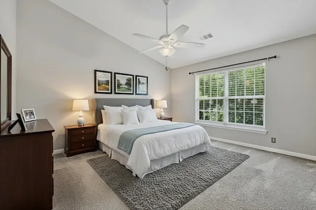 a spacious bedroom with a large bed and a window