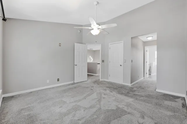 an empty room with fan and entrance