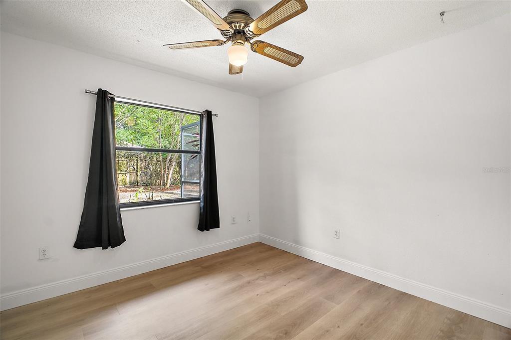 2309 Fairview Eustis, FL 32726 - Photo 17 of 27 an empty room with windows and fan