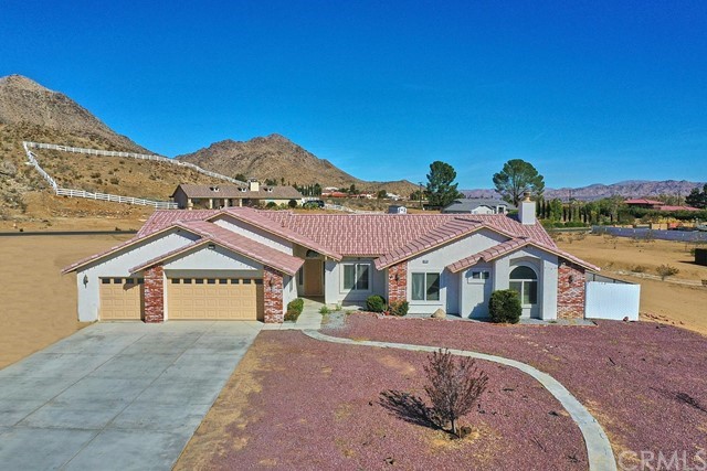 19786 Serrano Road Apple Valley, CA 92307 - Photo 1 of 1 a front view of a house with a yard and garage