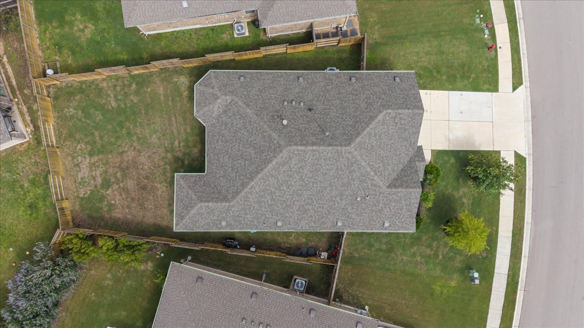 366 Cold Riv Run Kyle, TX 78640 - Photo 25 of 31 Overhead property view of shingled roof, paved driveway, and fenced backyard