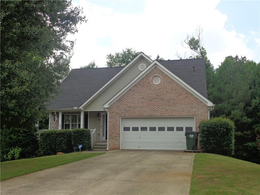 141 Stable Lane Dallas, GA 30132 - Photo 1 of 1 a front view of a house with a garden and yard