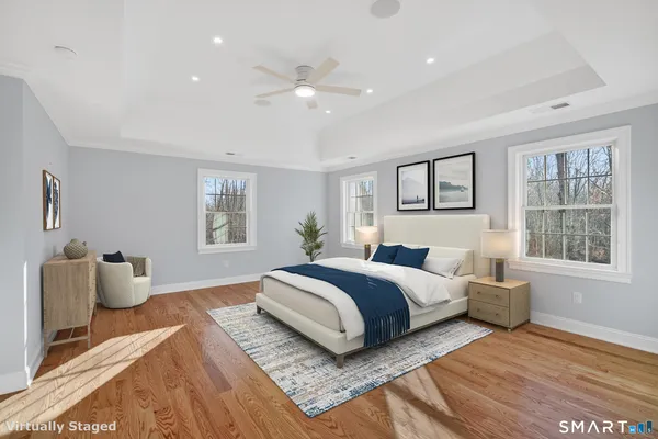 a spacious bedroom with a bed and a couch