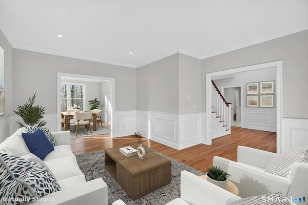 a living room with furniture and wooden floor