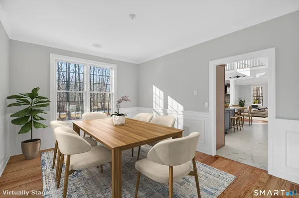 a view of a dining room with furniture window and wooden floor