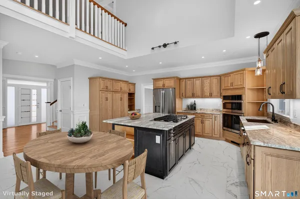a kitchen with kitchen island a sink stove and refrigerator