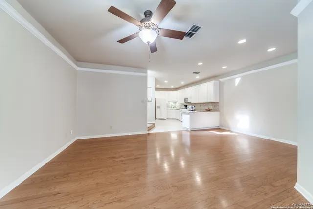 a view of an empty room with a ceiling fan