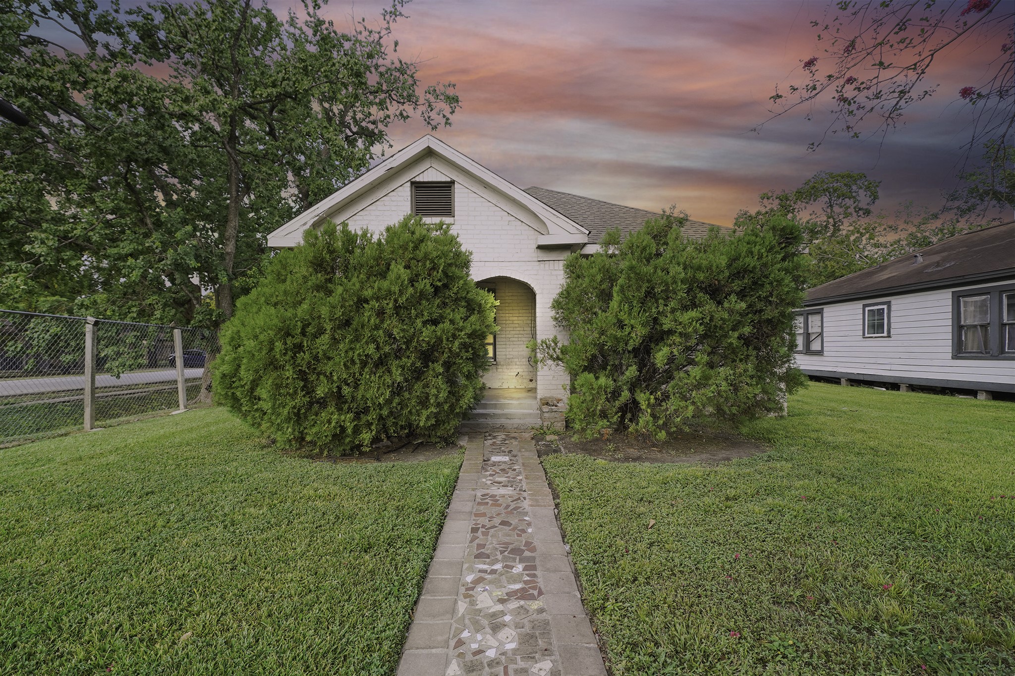 a front view of a house with garden